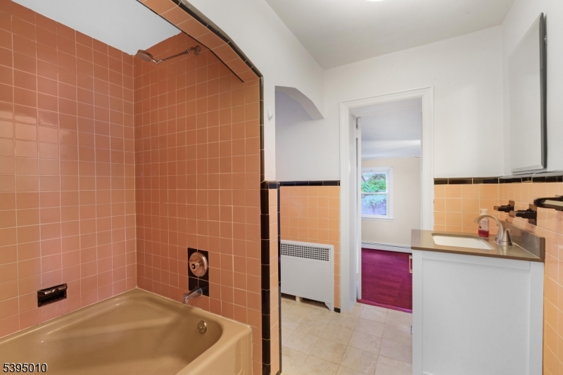 654 Suffern Road Teaneck, NJ 07666 - Photo 21 of 30 a bathroom with a tub and a sink