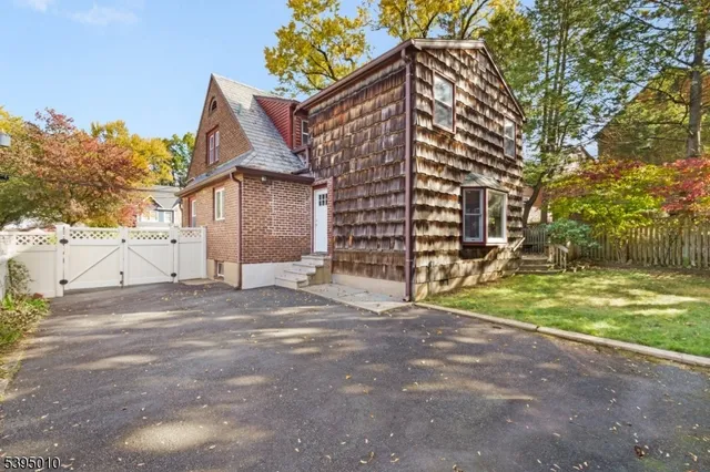 a view of a house with a yard and garage