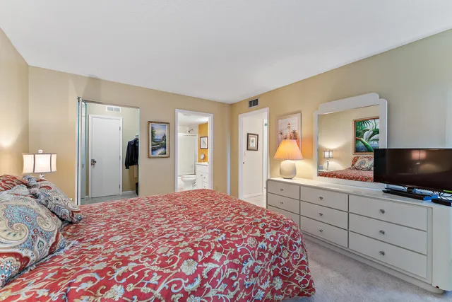 a bedroom with a large bed and a flat screen tv