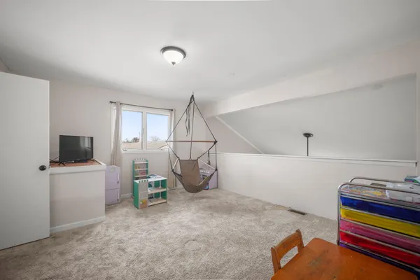 a work room with furniture and a flat screen tv