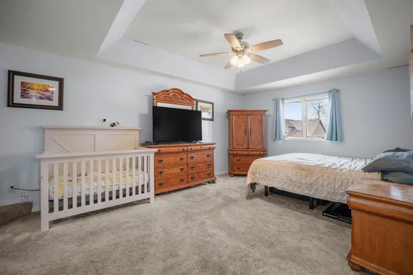 a bedroom with a bed and a chandelier