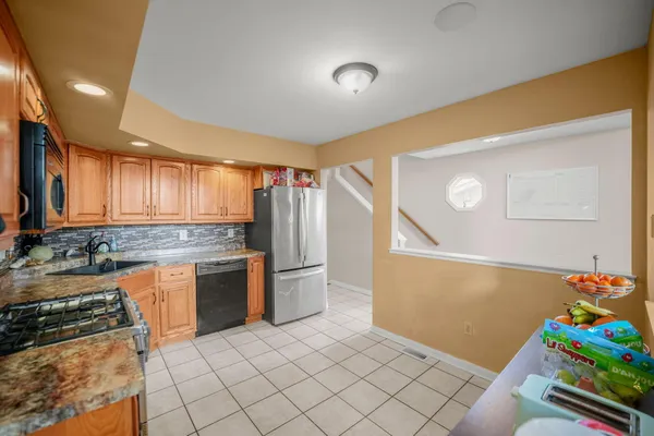 a kitchen with a stove a sink and a refrigerator