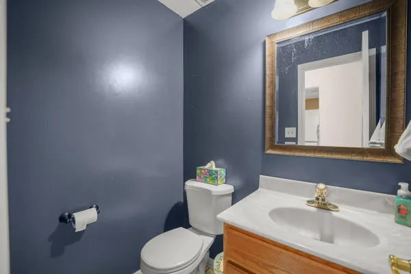 a bathroom with a sink mirror and toilet