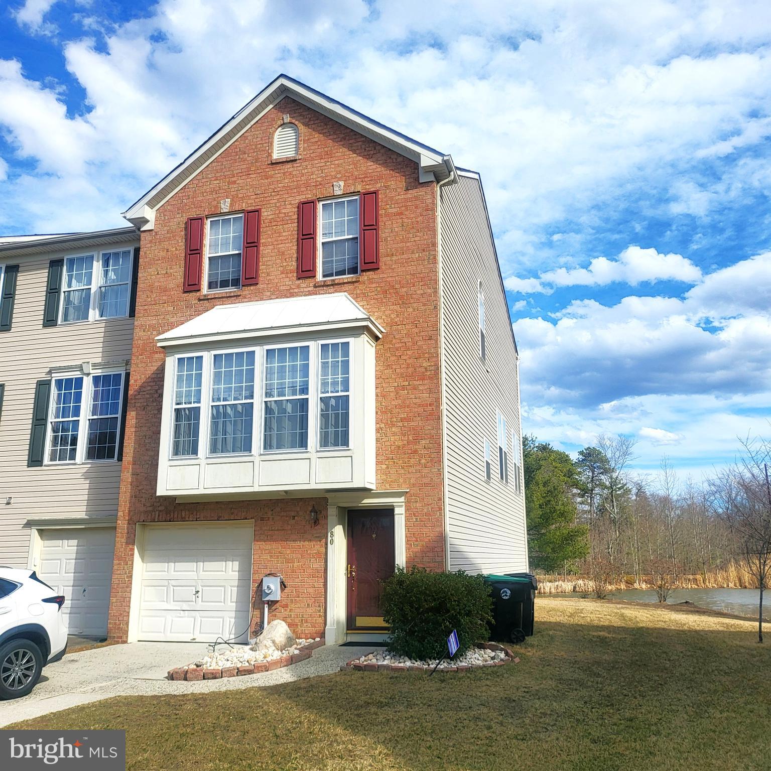 80 Colts Neck Drive Sicklerville, NJ 08081 - Photo 1 of 14 a front view of a house with a yard and garage
