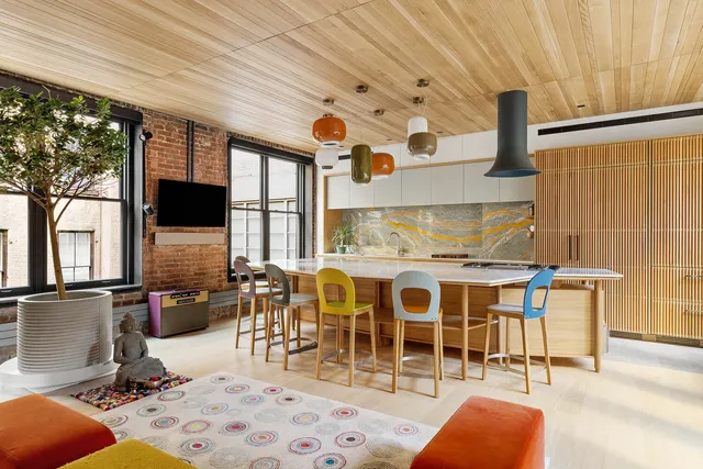 a view of a hallway with wooden floor and door