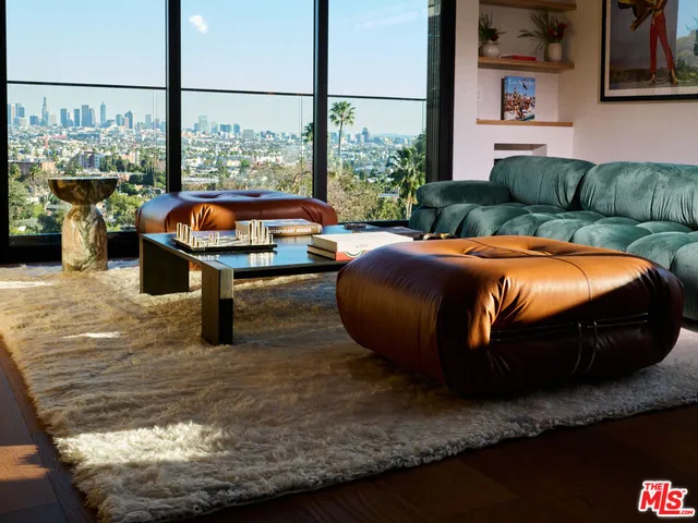 a room with furniture and a floor to ceiling window