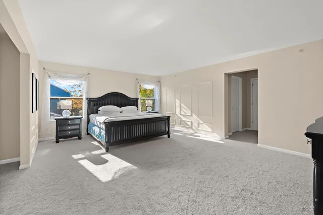 a spacious bedroom with a bed and window