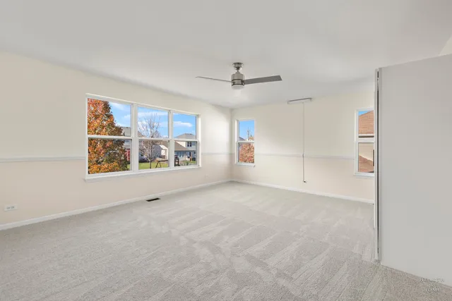 a view of an empty room with a ceiling fan