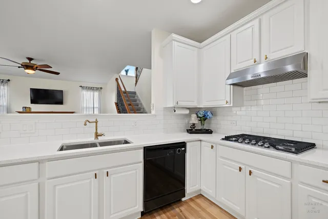 a kitchen with a sink stove and cabinets