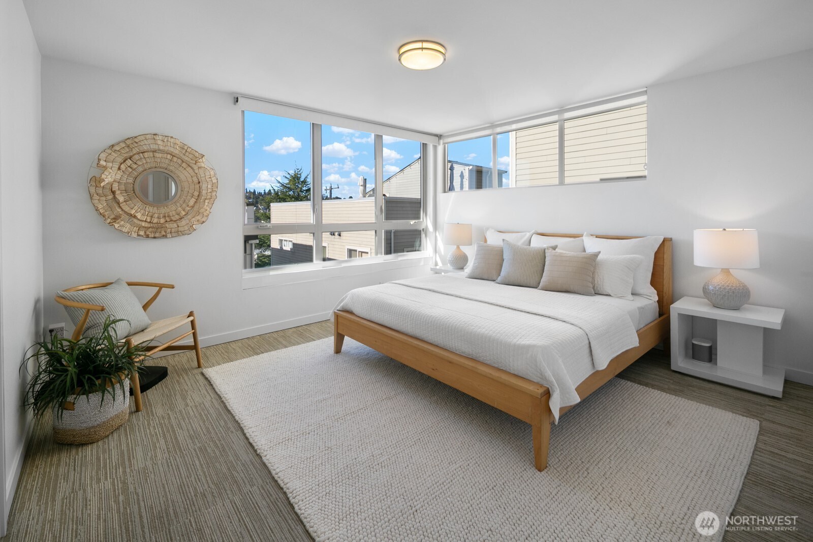 2808 14th Avenue West, Unit B Seattle, WA 98119 - Photo 12 of 39 a bedroom with a bed and a chandelier