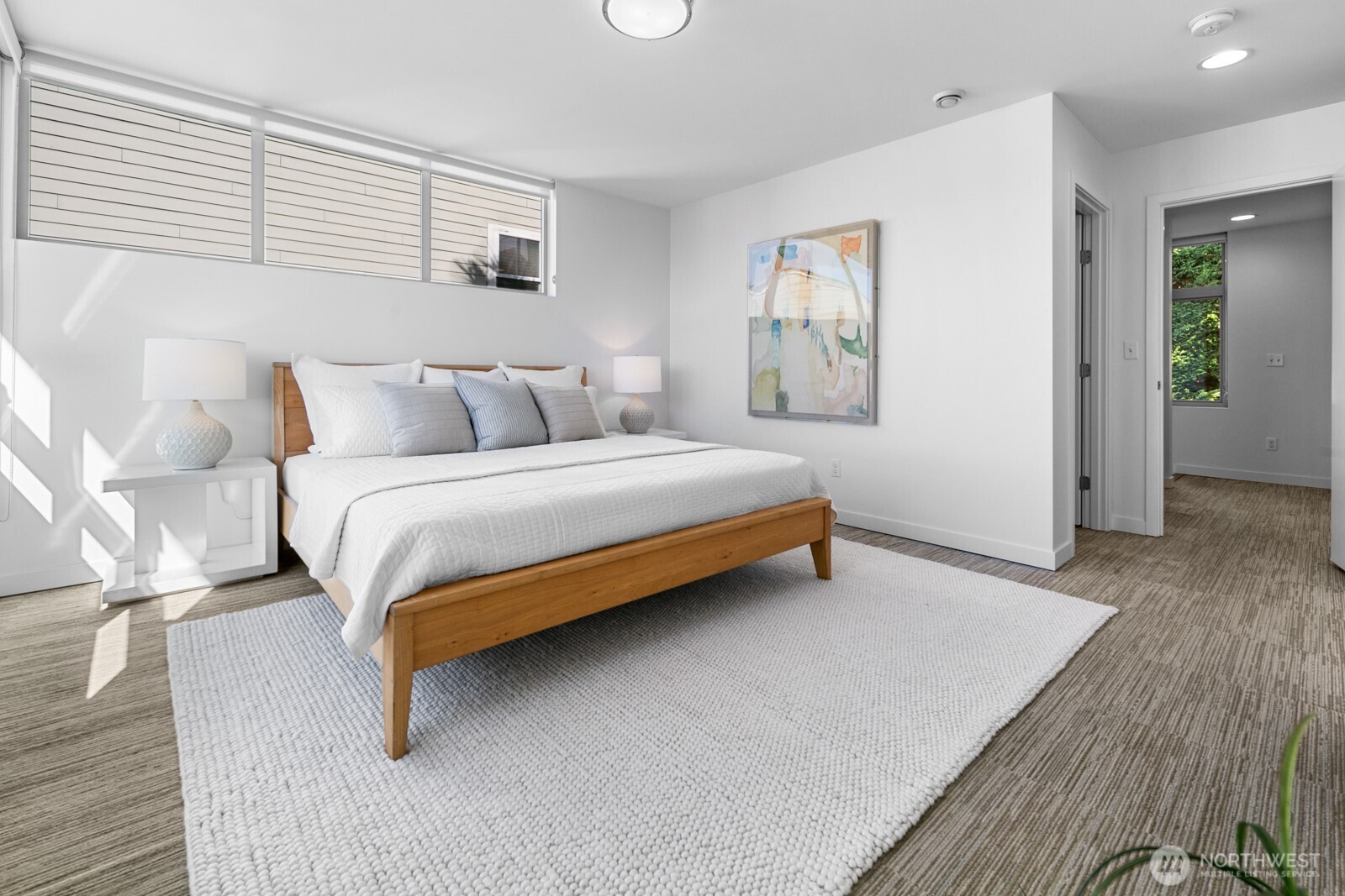 2808 14th Avenue West, Unit B Seattle, WA 98119 - Photo 13 of 39 a bedroom with a bed and wooden floor