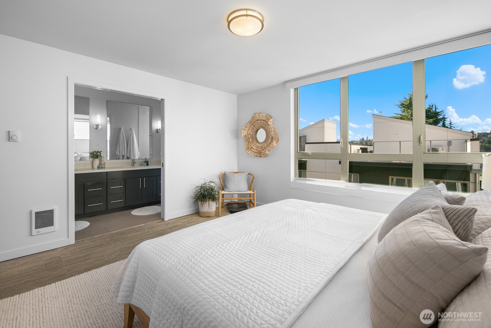 2808 14th Avenue West, Unit B Seattle, WA 98119 - Photo 15 of 39 a bedroom with a bed and a chandelier