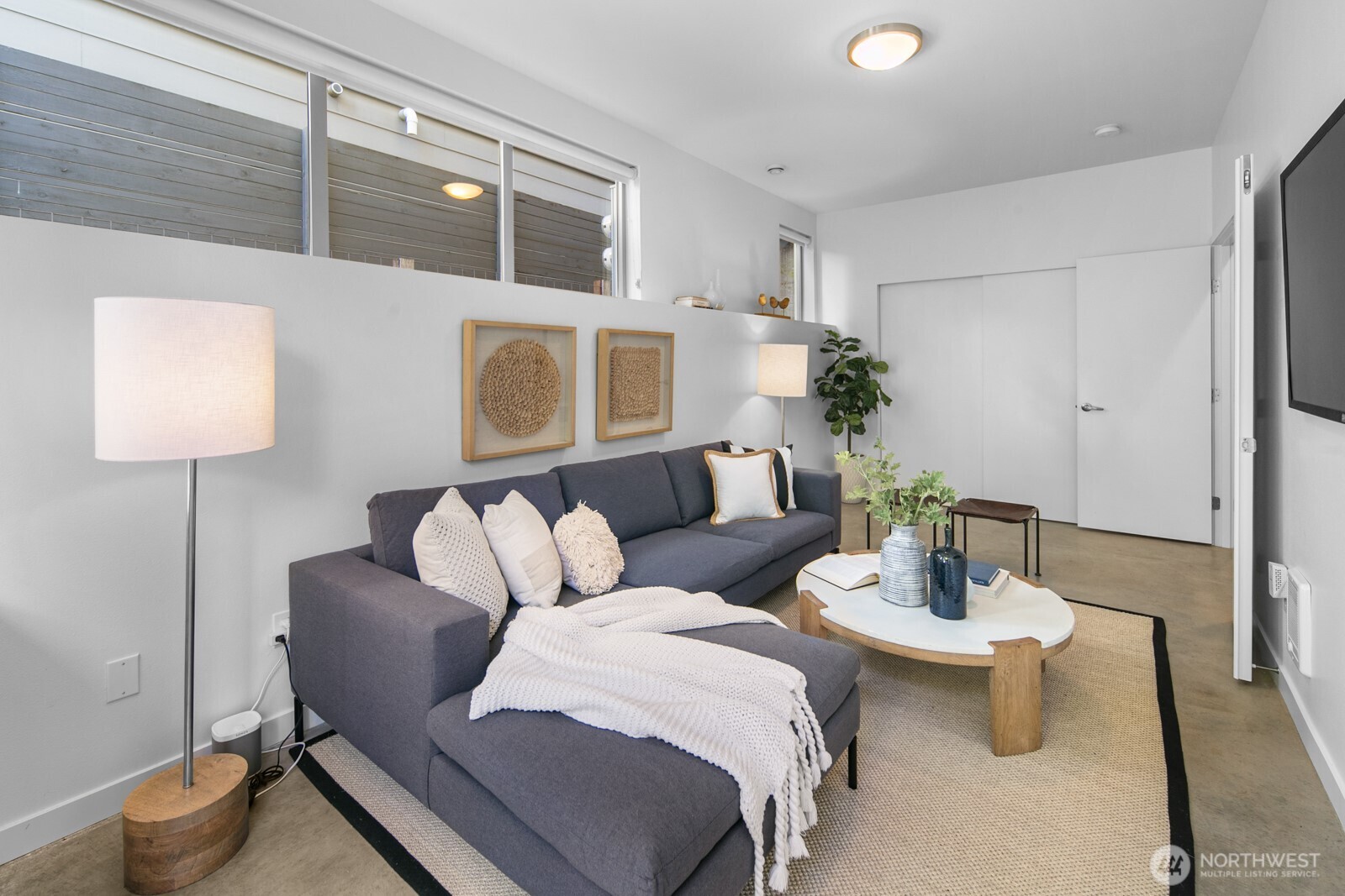 2808 14th Avenue West, Unit B Seattle, WA 98119 - Photo 24 of 39 a living room with furniture and a lamp