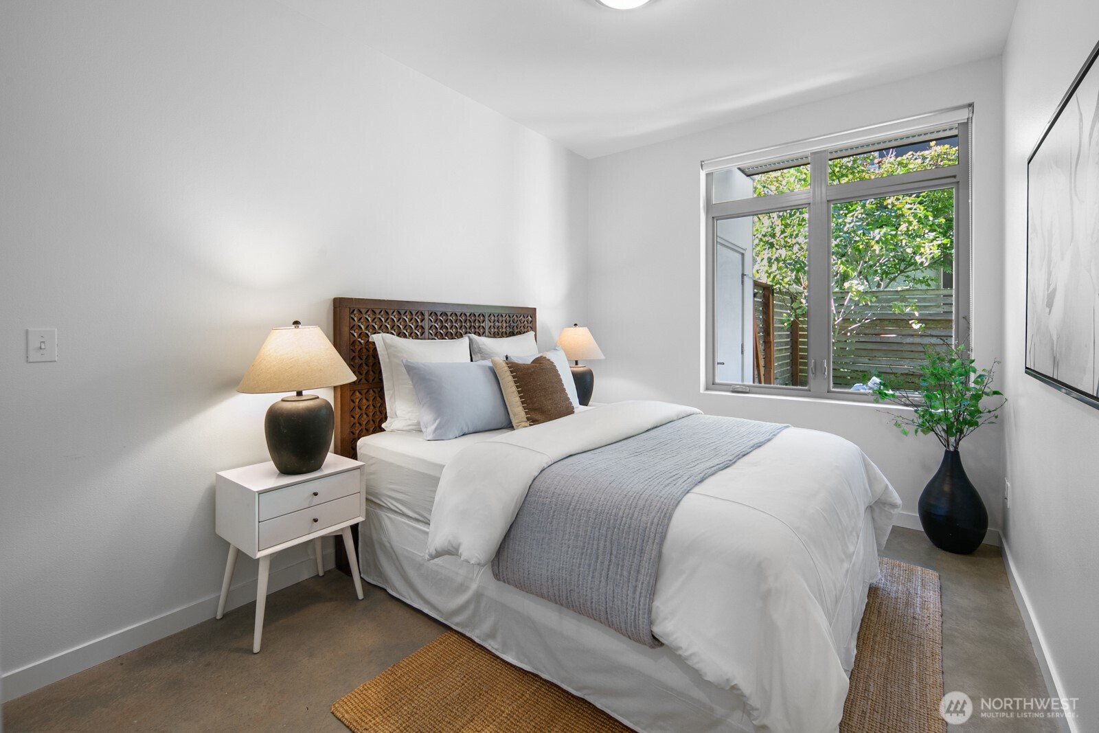 2808 14th Avenue West, Unit B Seattle, WA 98119 - Photo 25 of 39 a bedroom with a bed and window