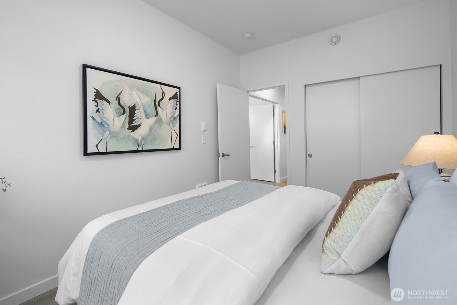 2808 14th Avenue West, Unit B Seattle, WA 98119 - Photo 27 of 39 a bedroom with a bed and a painting on the wall