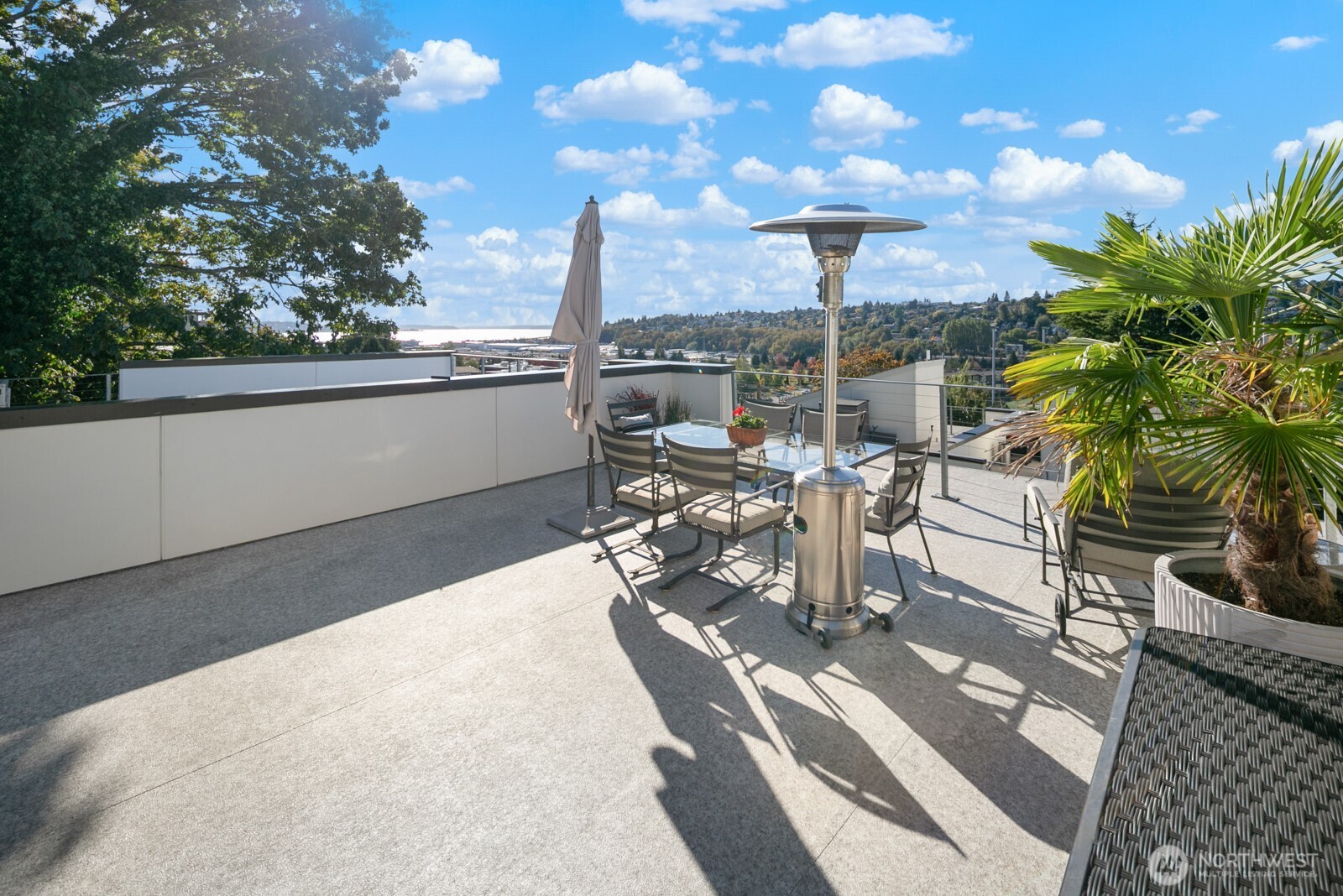 2808 14th Avenue West, Unit B Seattle, WA 98119 - Photo 32 of 39 a view of a patio with table and chairs potted plants with wooden floor