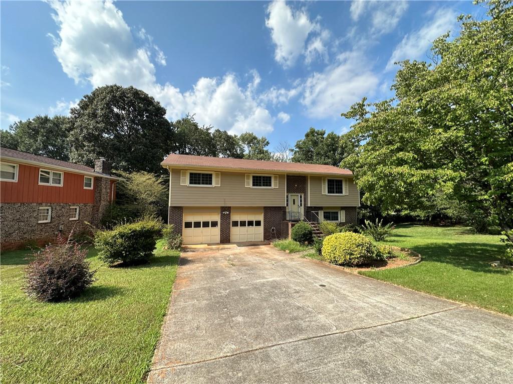 4666 Mercer Road Stone Mountain, GA 30083 - Photo 1 of 1 a view of a house with yard and a garden
