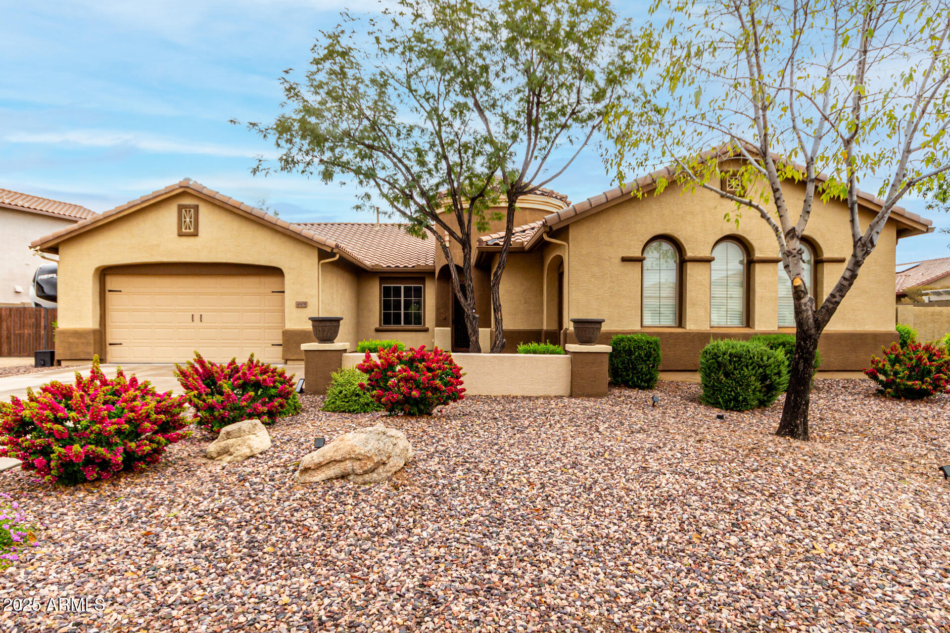 4808 West Cavalry Road Phoenix, AZ 85087 - Photo 1 of 67 a front view of a house with a flower garden