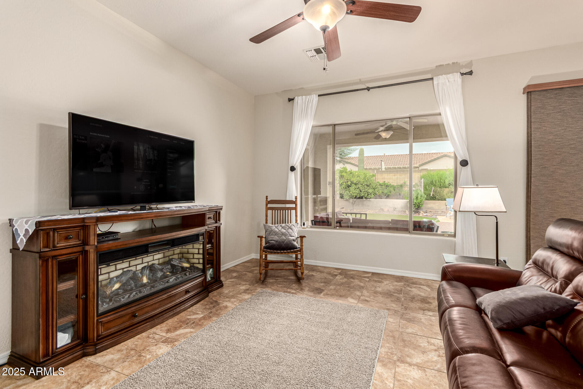 4808 West Cavalry Road Phoenix, AZ 85087 - Photo 10 of 67 a living room with furniture and a flat screen tv