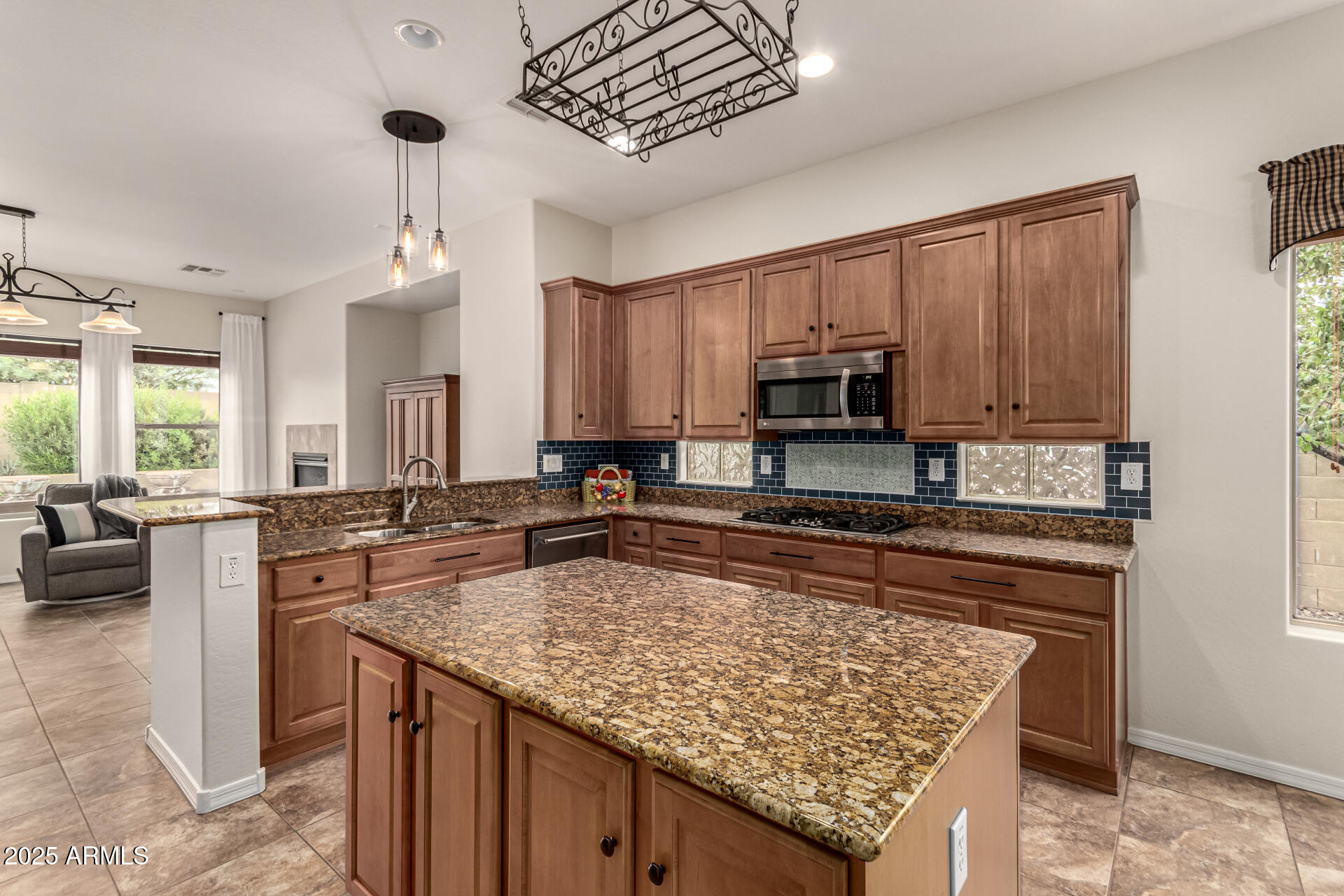 4808 West Cavalry Road Phoenix, AZ 85087 - Photo 14 of 67 a kitchen with granite countertop stainless steel appliances a sink stove and microwave