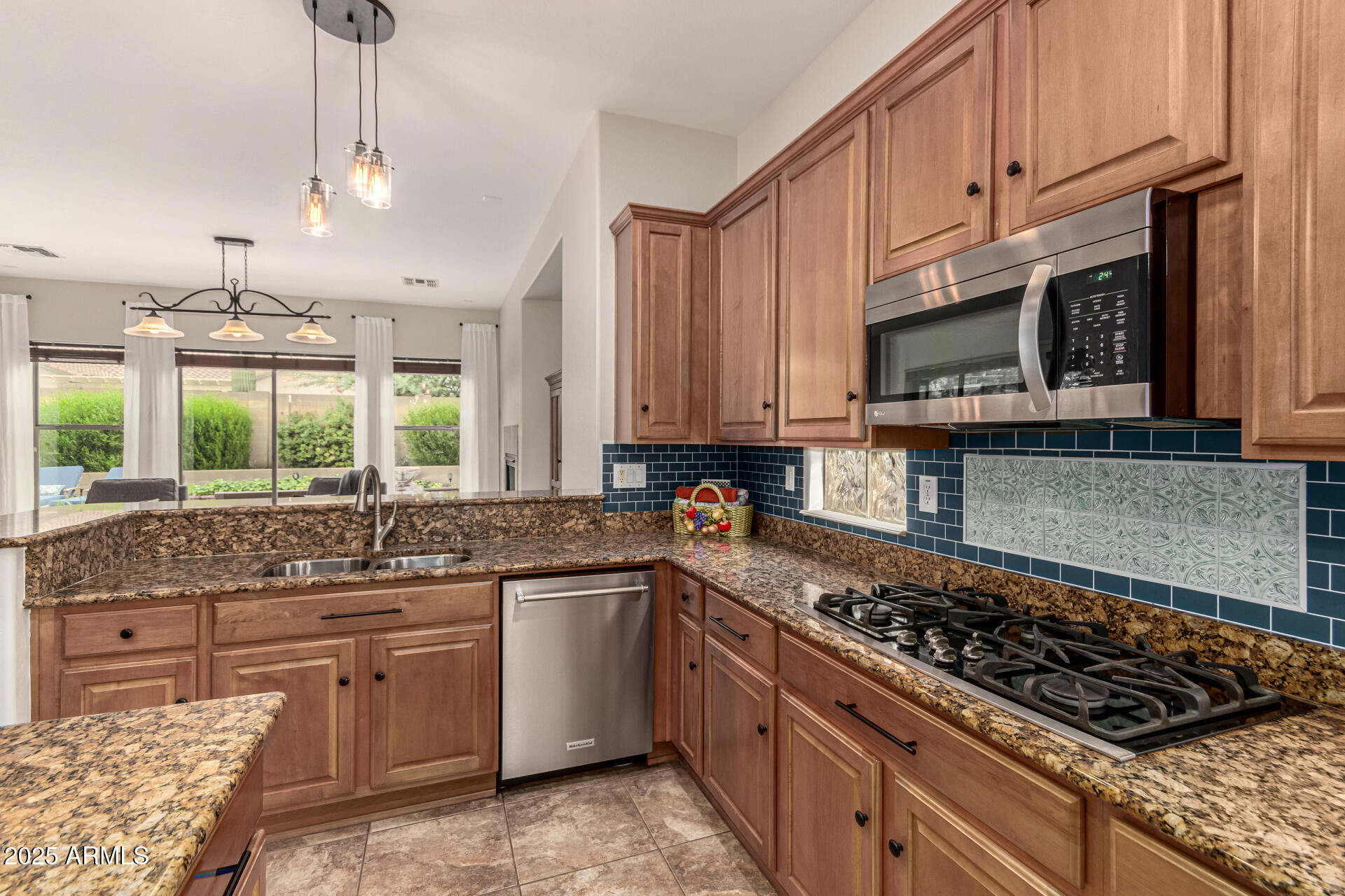 4808 West Cavalry Road Phoenix, AZ 85087 - Photo 19 of 67 a kitchen with stainless steel appliances a sink a stove and cabinets