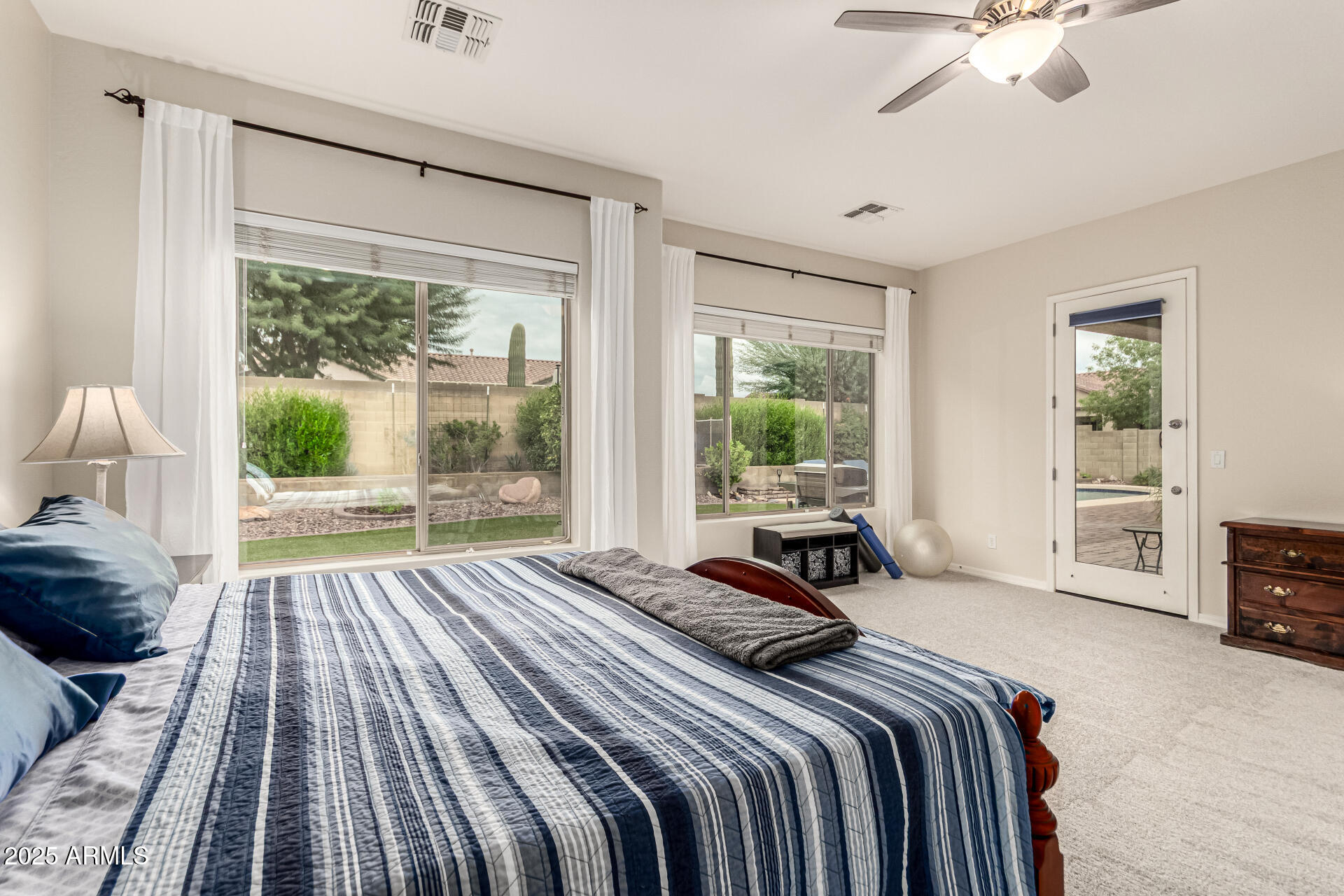 4808 West Cavalry Road Phoenix, AZ 85087 - Photo 20 of 67 a bedroom with a bed and a large window
