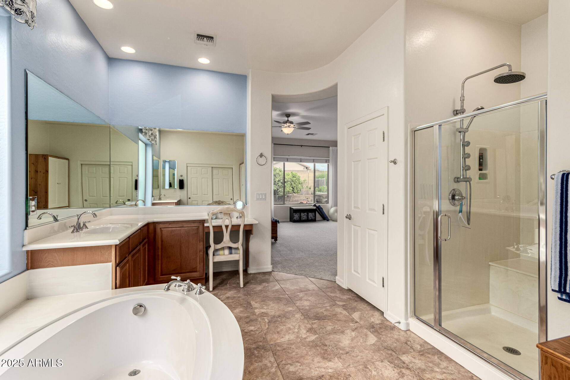 4808 West Cavalry Road Phoenix, AZ 85087 - Photo 24 of 67 a large white bathroom with a tub a sink and a large mirror