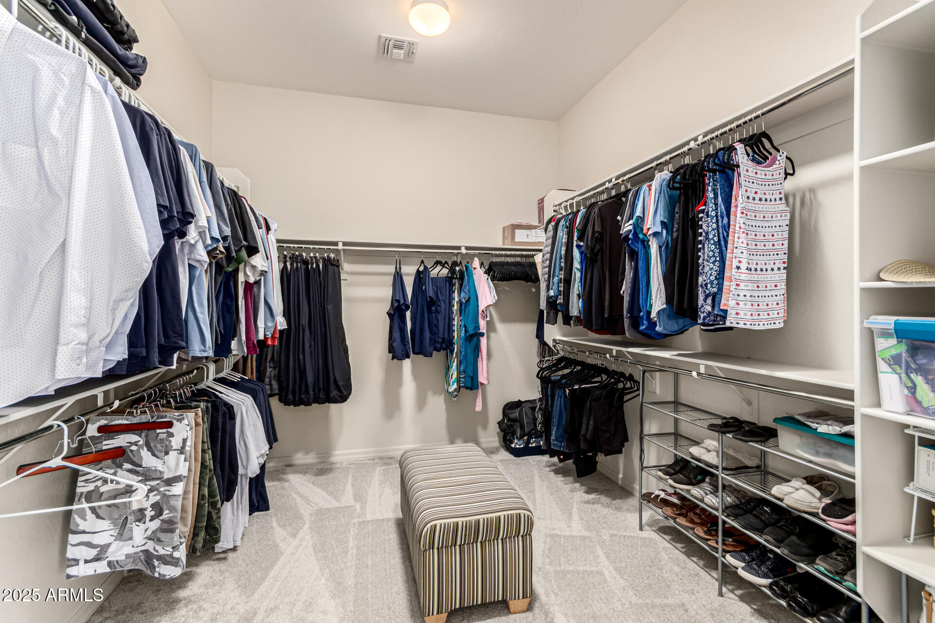 4808 West Cavalry Road Phoenix, AZ 85087 - Photo 26 of 67 a walk in closet with clothes and shoes