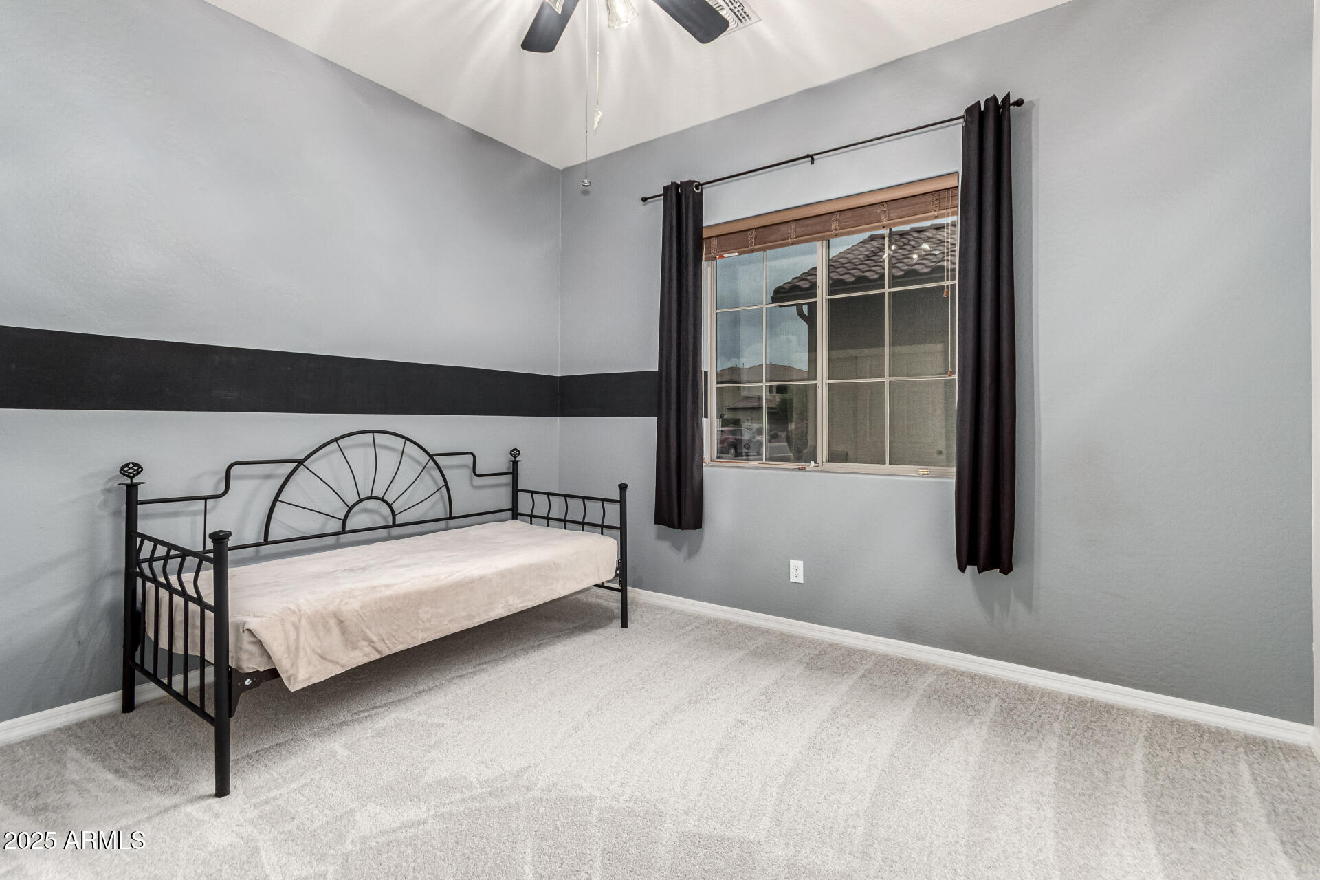 4808 West Cavalry Road Phoenix, AZ 85087 - Photo 29 of 67 a view of a bedroom with furniture and window