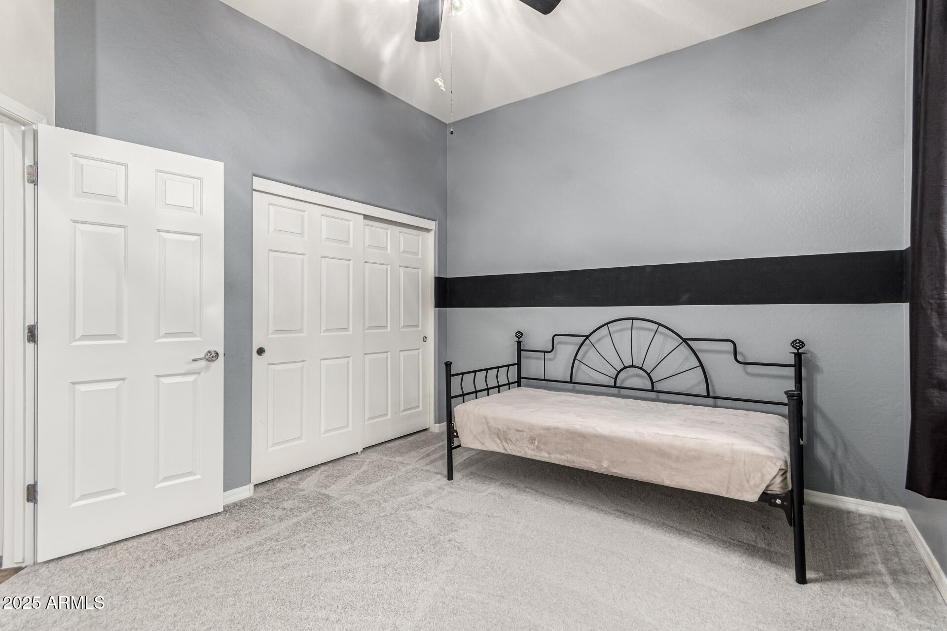 4808 West Cavalry Road Phoenix, AZ 85087 - Photo 30 of 67 a bedroom with a bed and a ceiling fan