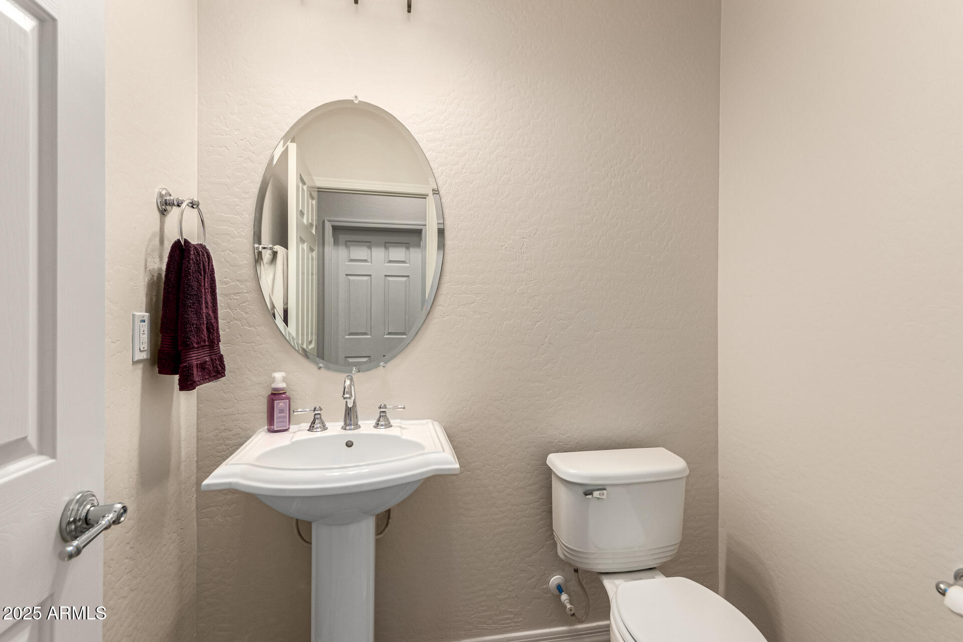 4808 West Cavalry Road Phoenix, AZ 85087 - Photo 37 of 67 a bathroom with a toilet sink and mirror