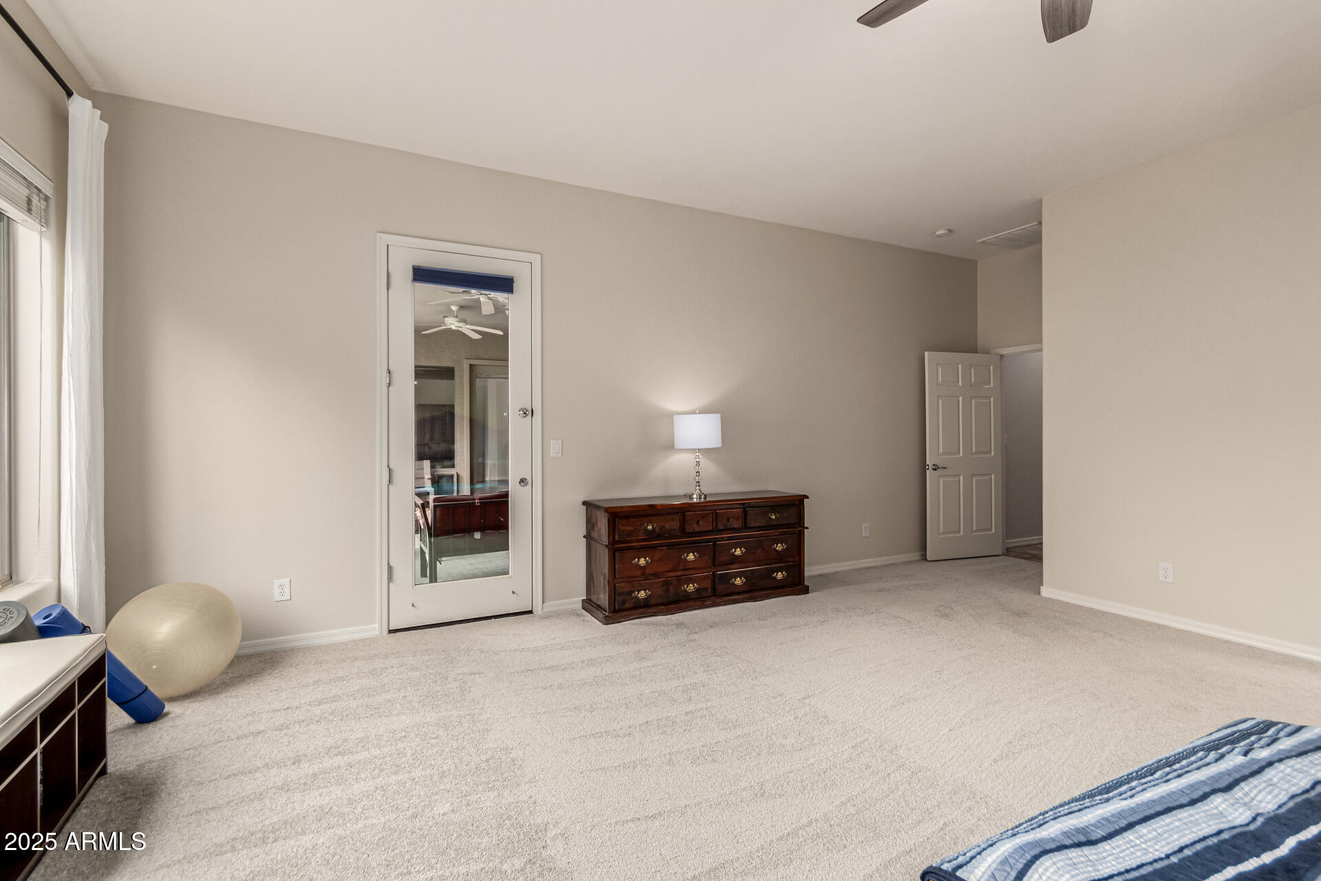 4808 West Cavalry Road Phoenix, AZ 85087 - Photo 61 of 67 a bedroom with a bed and cabinets