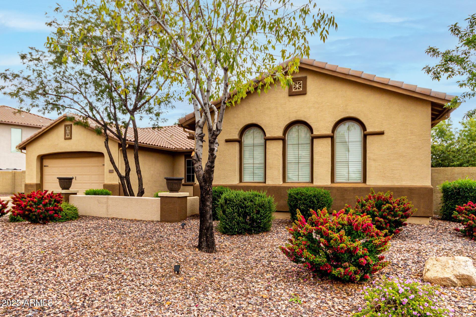 4808 West Cavalry Road Phoenix, AZ 85087 - Photo 63 of 67 a front view of a house with a garden