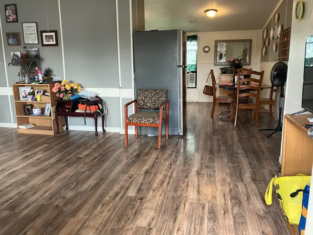 a dining room with furniture and wooden floor