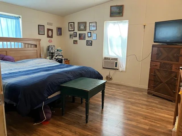 a bedroom with furniture and wooden floor