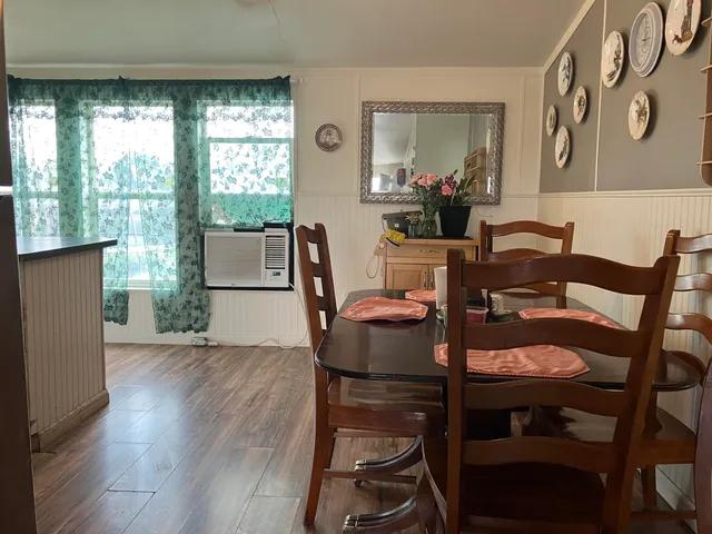 a dining room with furniture and window