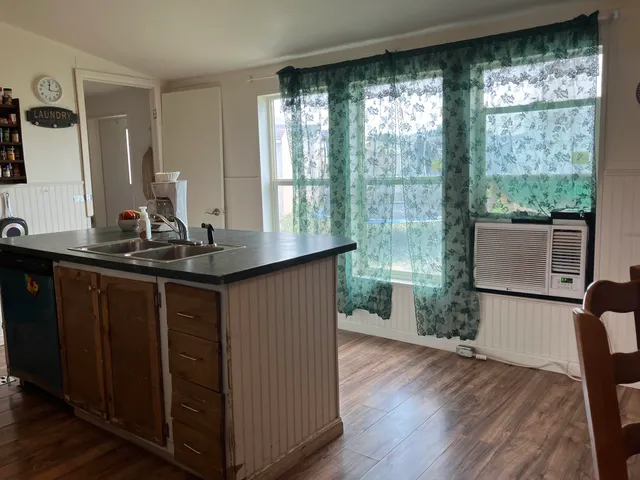 a kitchen with sink and large window