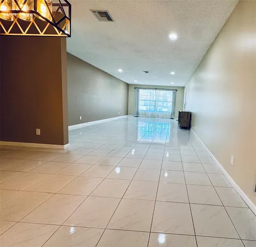 a bedroom with a bed and a flat tv screen on dresser