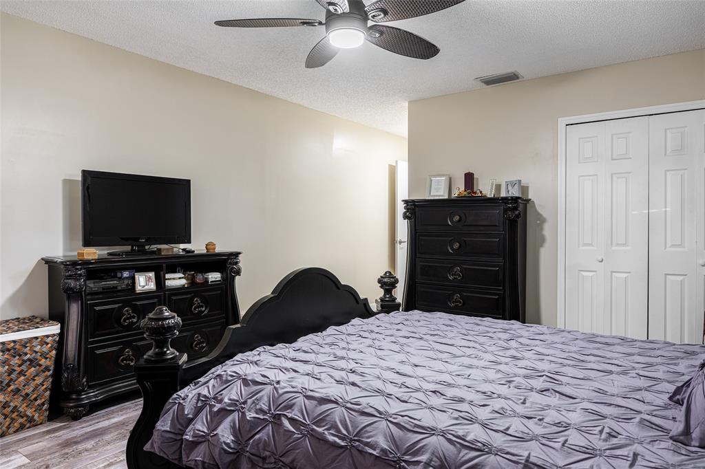 9870 Pecan Tree Drive, Unit B Boynton Beach, FL 33436 - Photo 15 of 33 a bedroom with a bed and a flat tv screen on dresser