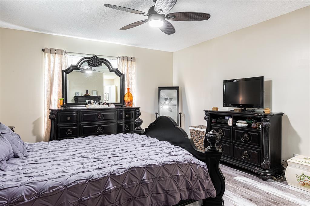 9870 Pecan Tree Drive, Unit B Boynton Beach, FL 33436 - Photo 16 of 33 a bedroom with a bed and a flat screen tv
