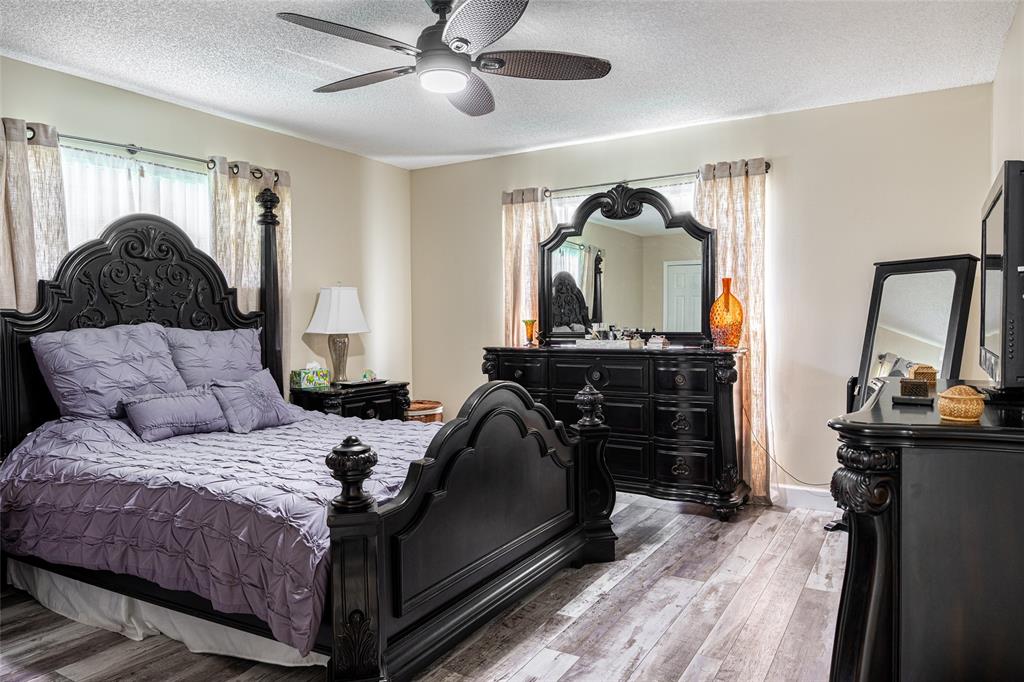 9870 Pecan Tree Drive, Unit B Boynton Beach, FL 33436 - Photo 17 of 33 a bedroom with a bed and a mirror