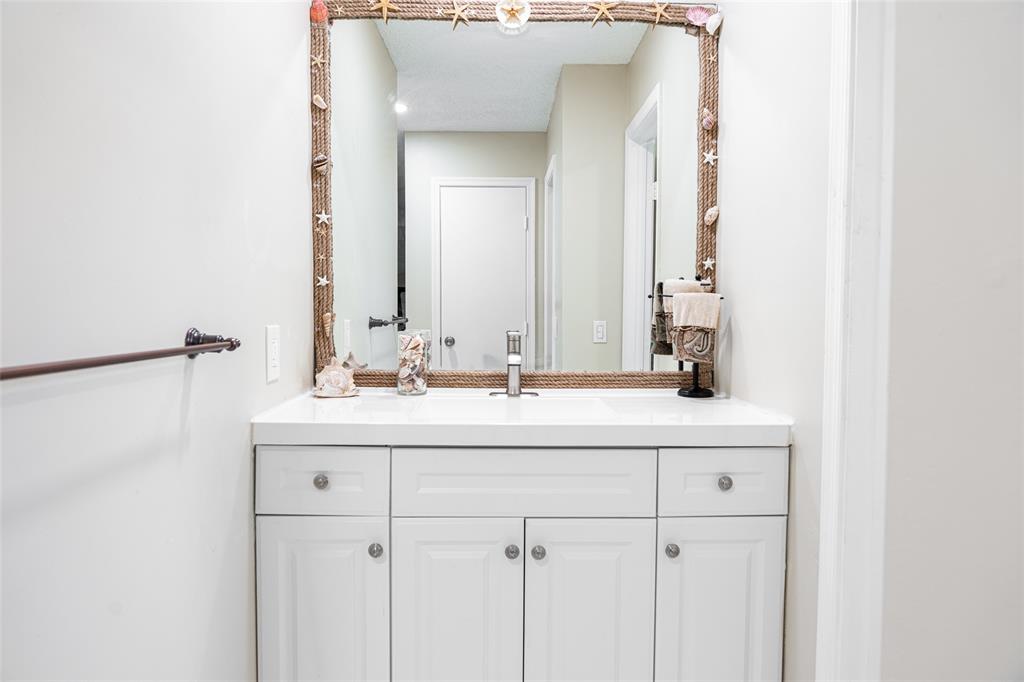 9870 Pecan Tree Drive, Unit B Boynton Beach, FL 33436 - Photo 19 of 33 a bathroom with a sink and a mirror