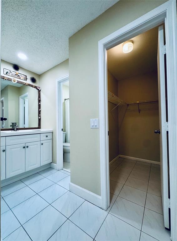 9870 Pecan Tree Drive, Unit B Boynton Beach, FL 33436 - Photo 20 of 33 a bathroom with a mirror a sink and a shower