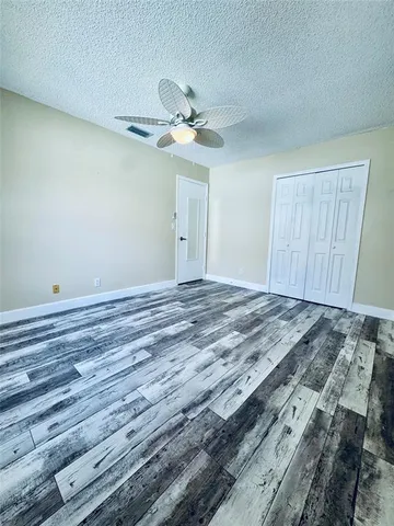 a living room with furniture a rug and a bookshelf