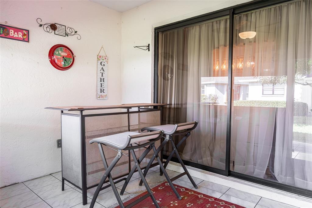 9870 Pecan Tree Drive, Unit B Boynton Beach, FL 33436 - Photo 26 of 33 a view of a room with furniture and window