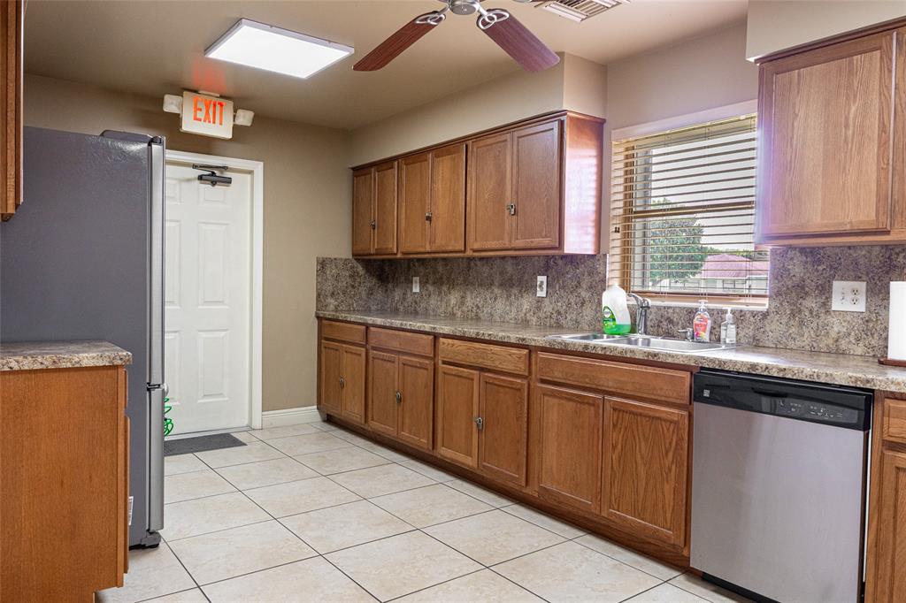 9870 Pecan Tree Drive, Unit B Boynton Beach, FL 33436 - Photo 32 of 33 a kitchen with stainless steel appliances granite countertop a sink and a refrigerator