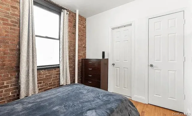 a view of a bedroom with closet and furniture