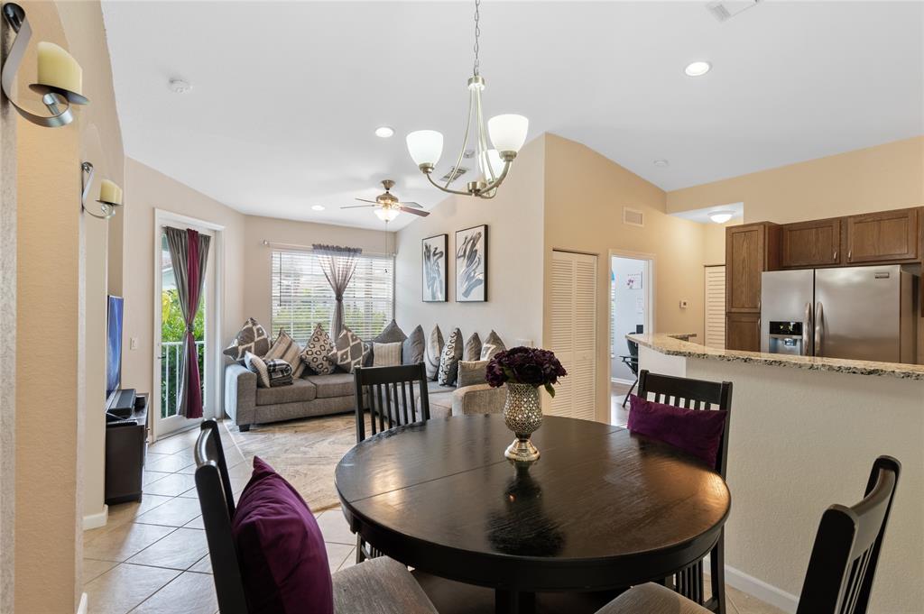 3067 Laurel Ridge Circle Riviera Beach, FL 33404 - Photo 11 of 27 a view of a dining room with furniture and a chandelier