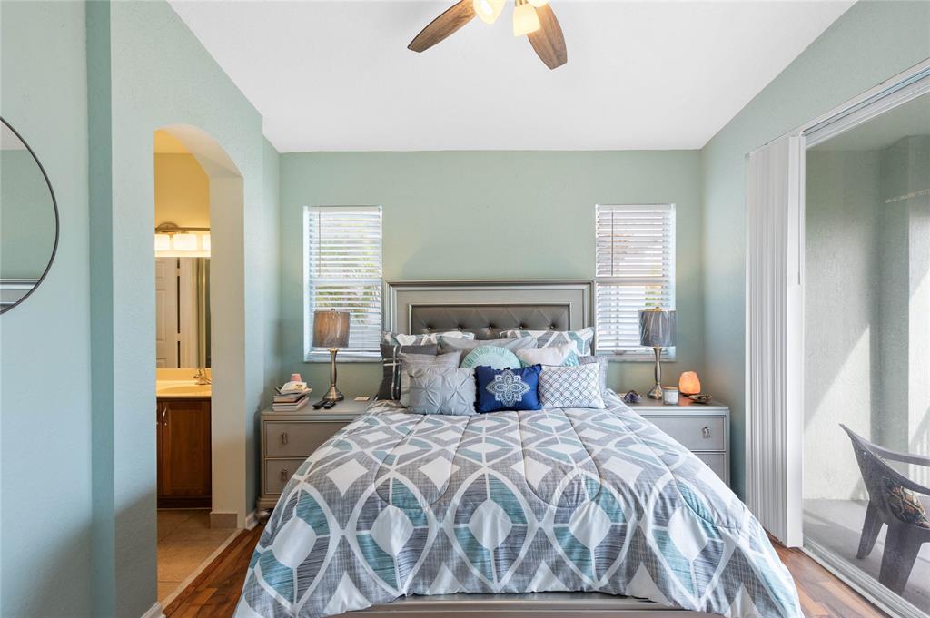 3067 Laurel Ridge Circle Riviera Beach, FL 33404 - Photo 16 of 27 a bedroom with a bed and a chandelier