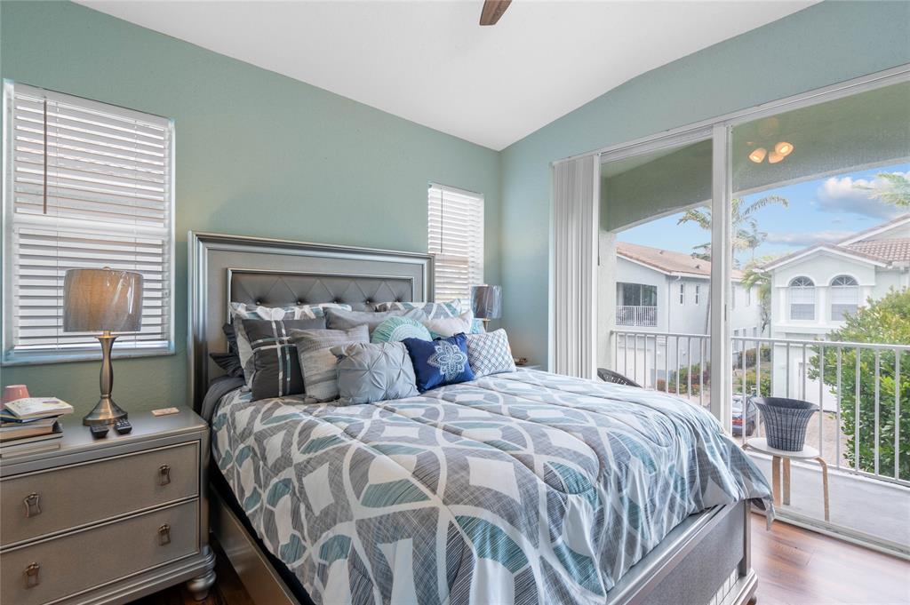 3067 Laurel Ridge Circle Riviera Beach, FL 33404 - Photo 17 of 27 a bed sitting in a bedroom next to a window